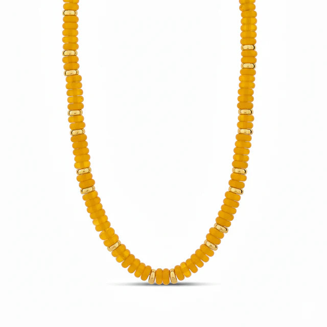 18k gold plated over brass 

Mustard color tones pukka necklace with gold disks in between 

12 inches plus a 4 inch extension chain 